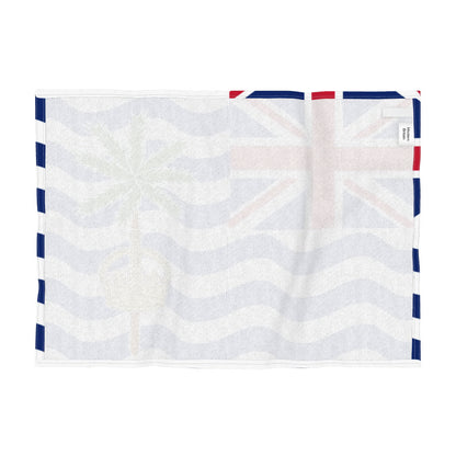 Reverse side of a tea towel of the flag of the British Indian Ocean Territories, featuring a Union Jack in the upper left, blue and white wavy stripes, a green palm tree, and a gold crown, shown flat against a white background.
