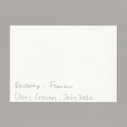 A white card with handwritten text in the lower left corner reading 'Duchamp: Fountain, Chris Coombes, July 2026', centered on a neutral grey background.