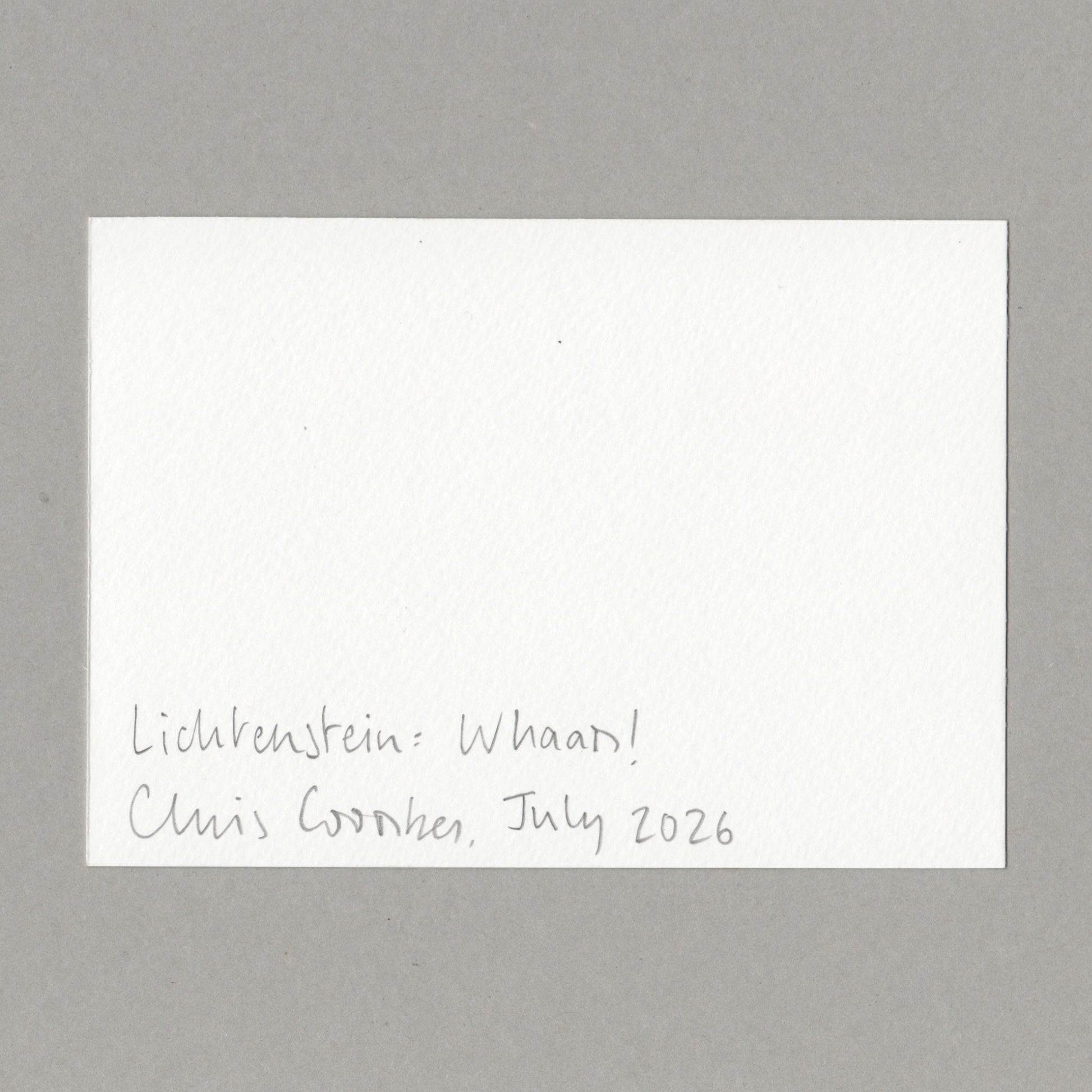 A white card with handwritten text in the lower left corner reading 'Lichtenstein: Whaam! Chris Coombes, July 2026', photographed against a plain grey background.