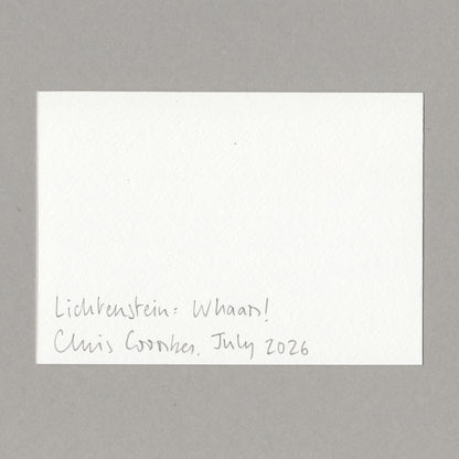 A white card with handwritten text in the lower left corner reading 'Lichtenstein: Whaam! Chris Coombes, July 2026', photographed against a plain grey background.