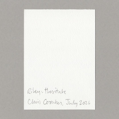 A white art card with handwritten text at the bottom, placed on a neutral gray background. The handwritten text reads 'Riley - Hesitate' and 'Chris Coombes, July 2026'.